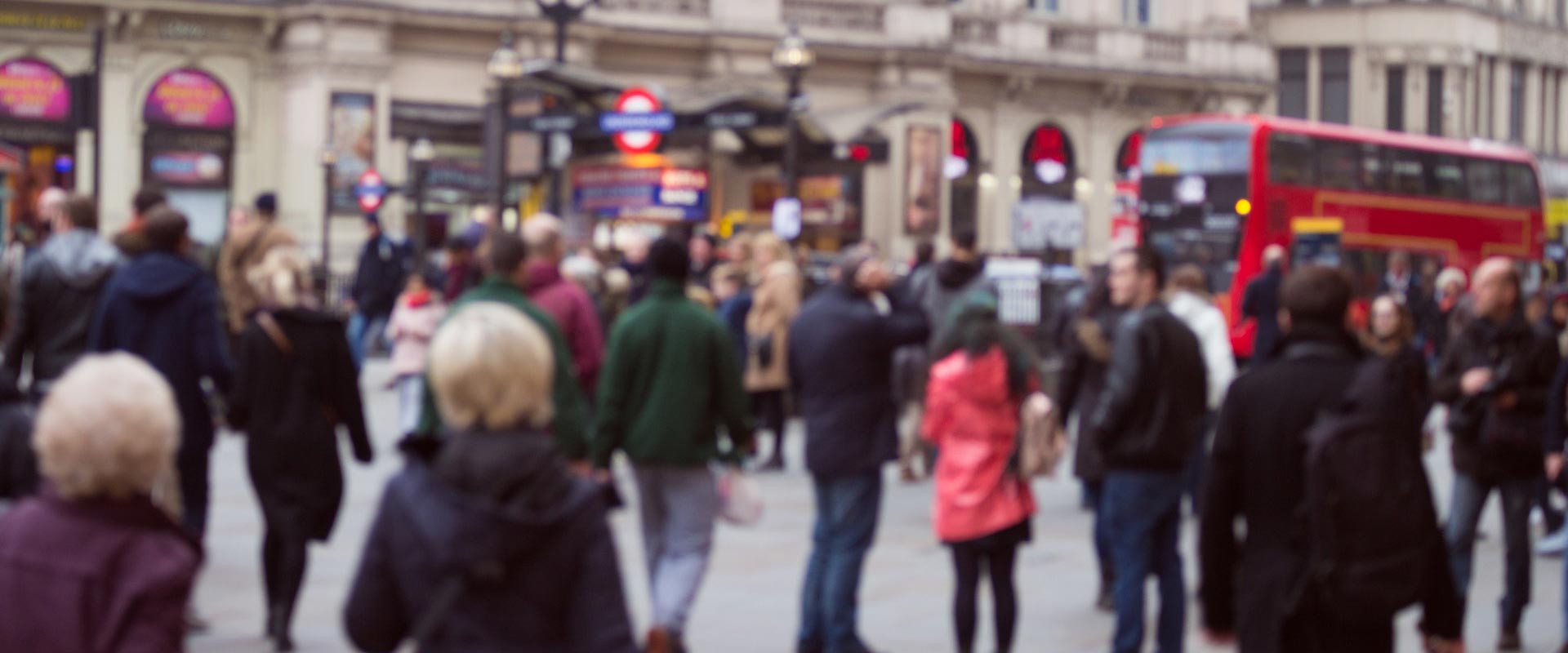 A photo of a busy street in London, with a pedestrians and vehicles in the background.