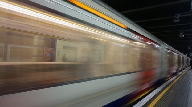 A blurred photo of a train passing by at speed. Lightweight mobility scooters are ideal for travelling on trains.