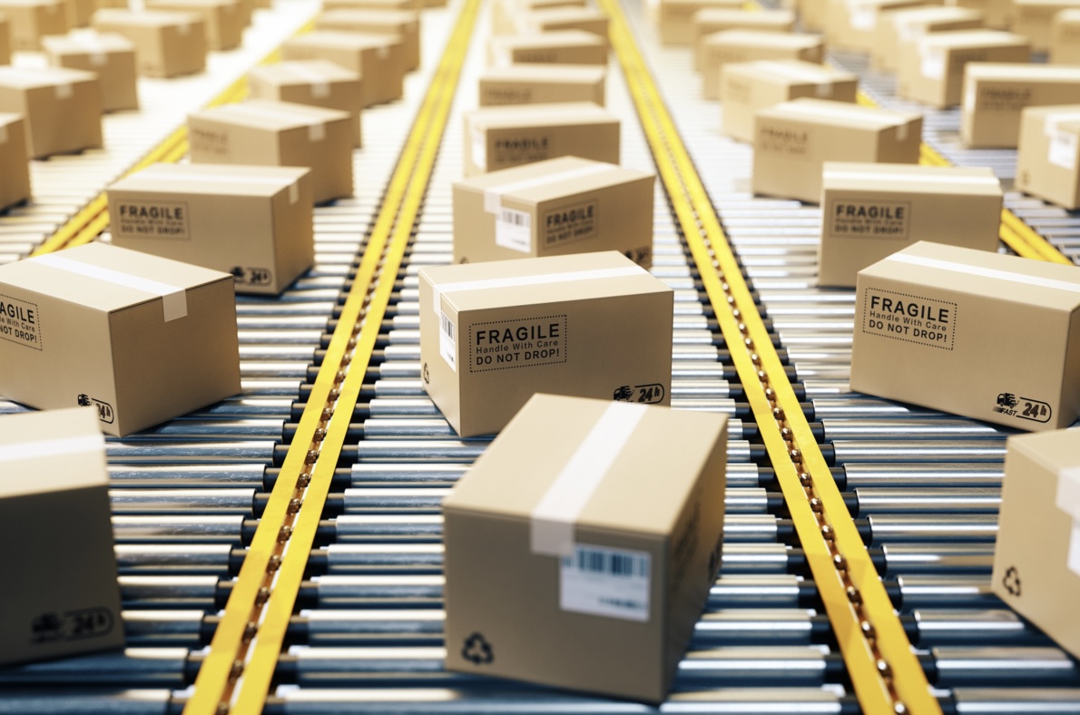 Cardboard boxes labelled 'FRAGILE' on conveyor belts, depicting the hazards of purchasing mobility products online.